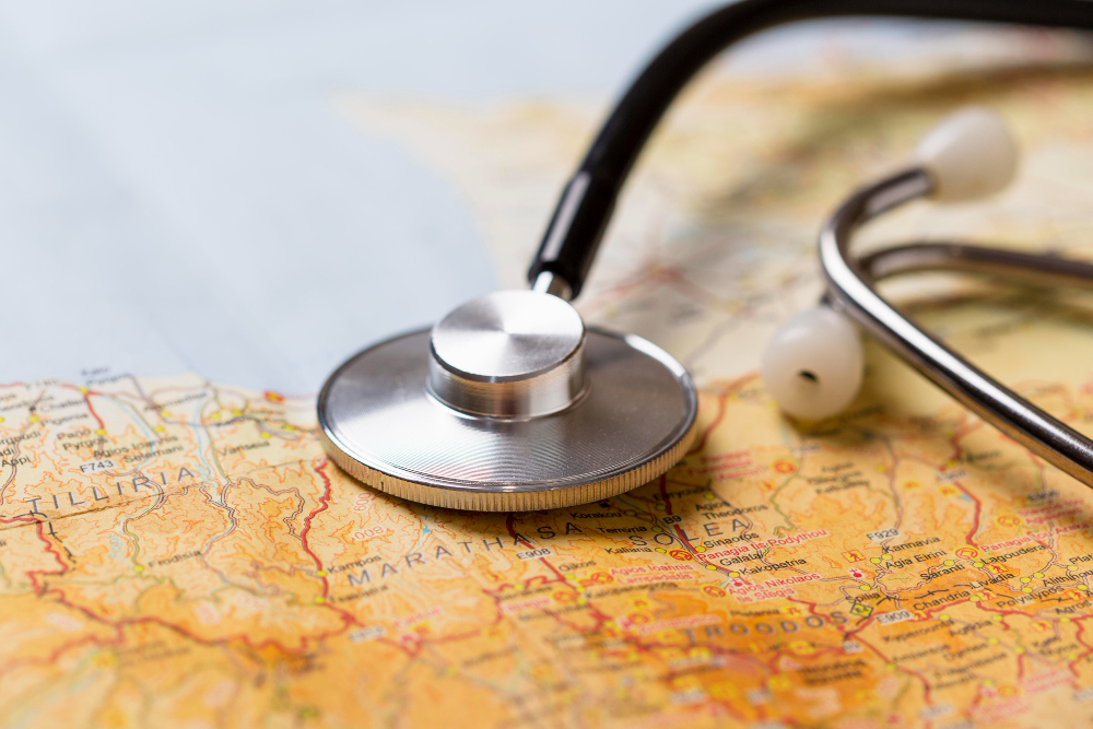 Medical stethoscope placed on a world map with a passport, illustrating the risks associated with medical tourism and 'surgery holidays'.